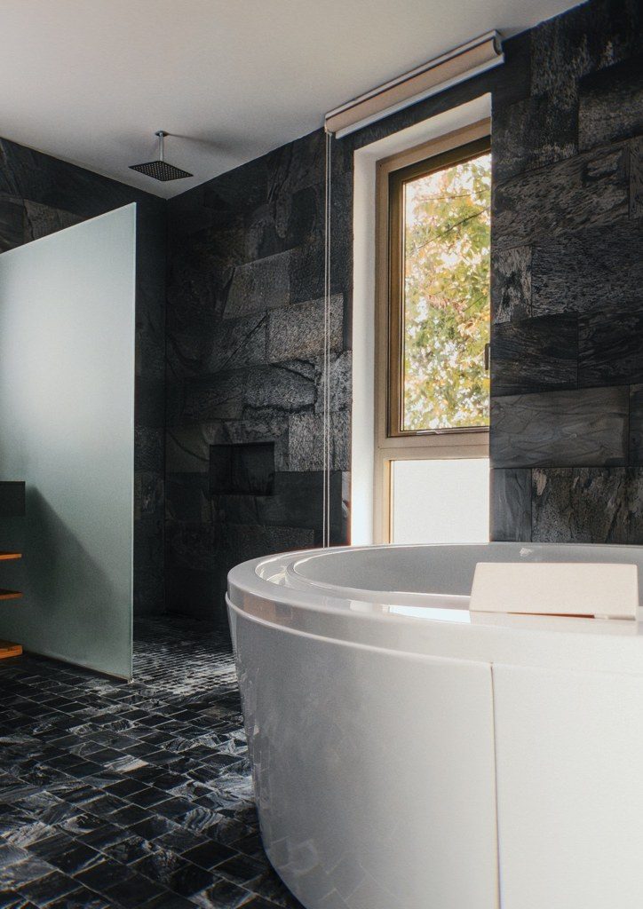 Bathroom in black stone with freestanding tub