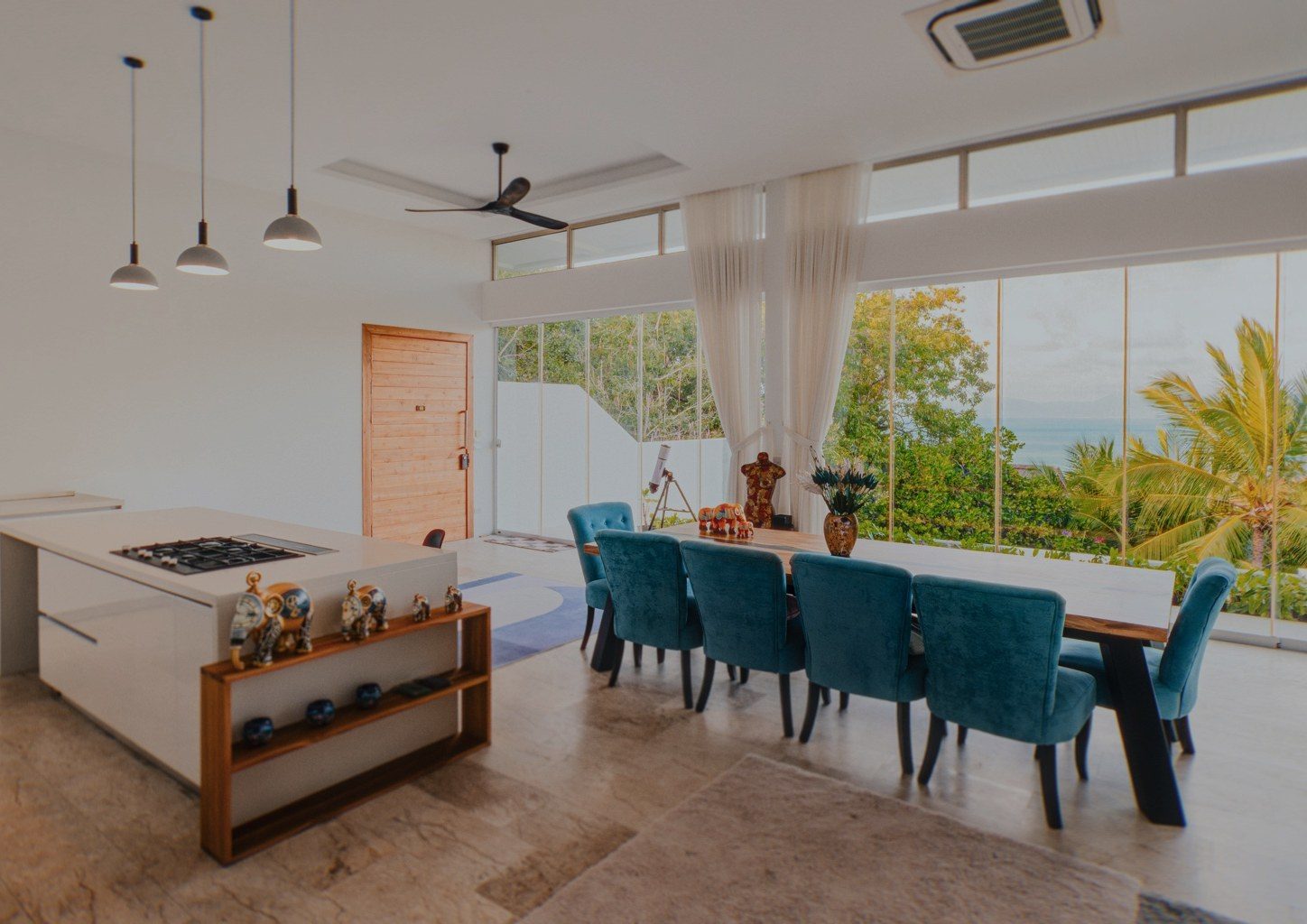 Open-plan kitchen and dining room with floor-to-ceiling windows