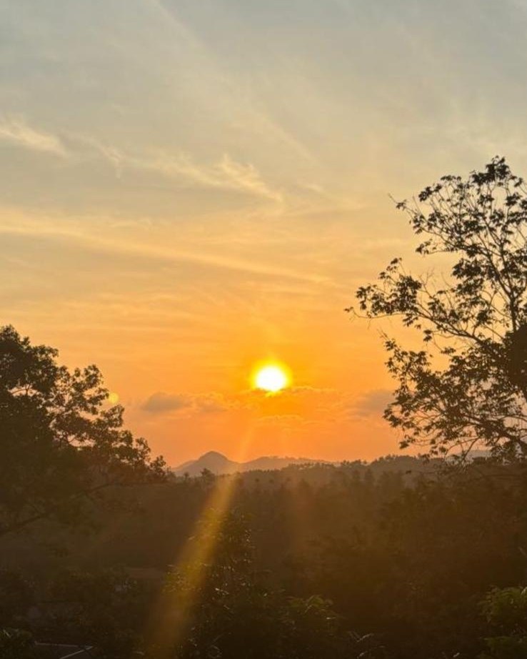 Sunset over the hills of Koh Samui, seen from a villa terrace